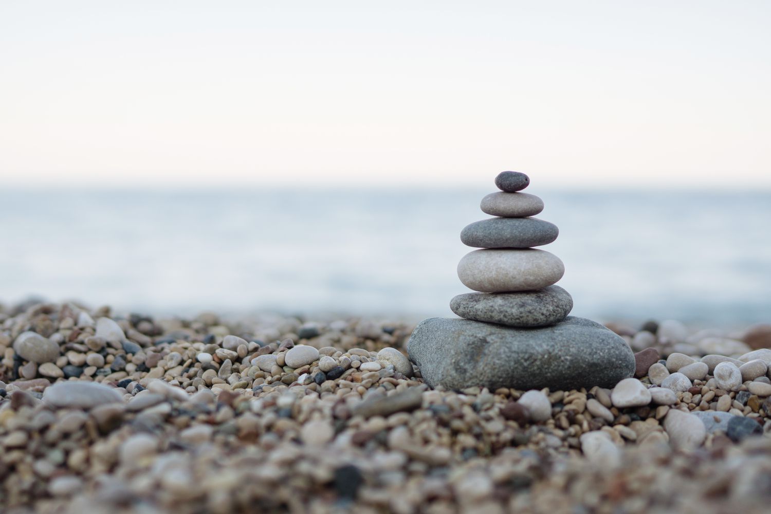 balanced-stones-on-a-pebble-beach-875372302-5a91e16bc673350037f6c2ca
